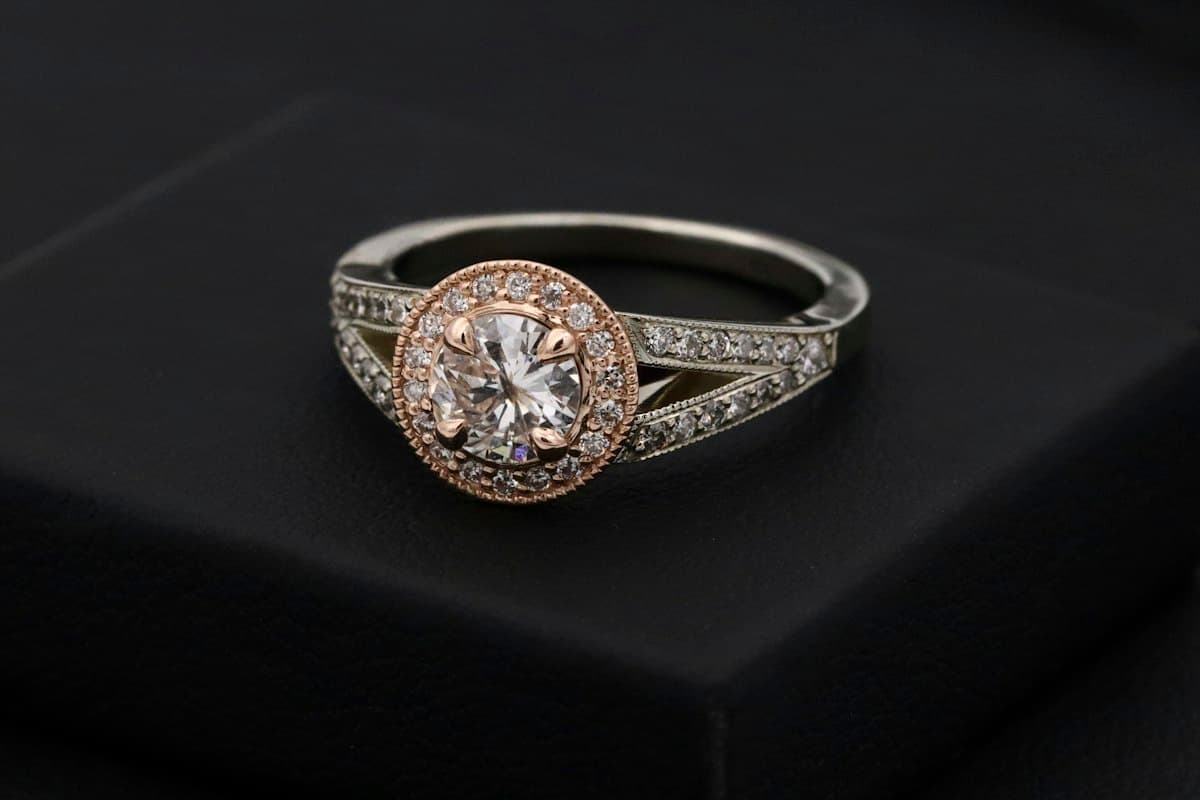 Diamond halo ring displayed on a black box